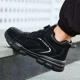 Black 8012 steel toe work boot with dial closure worn on outdoor steps